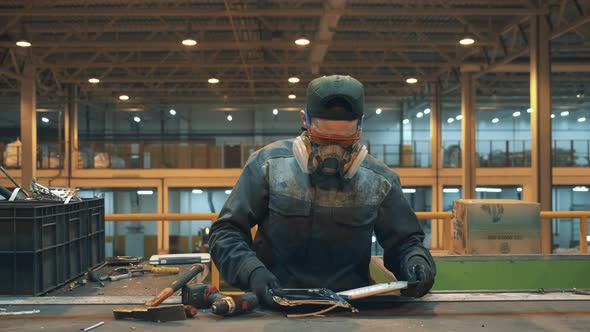 Recycling Facility Worker Sorts Electornic Garbage.