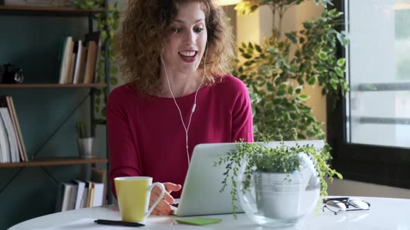 Businesswoman using laptop for video call at home