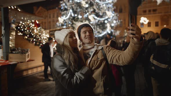 Loving Couple Taking Selfie at Night Market in Prague