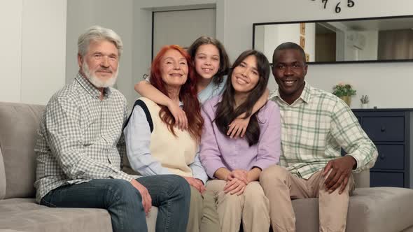 Portrait of Multi Ethnic Family of Different Age Generations at Home on the Sofa