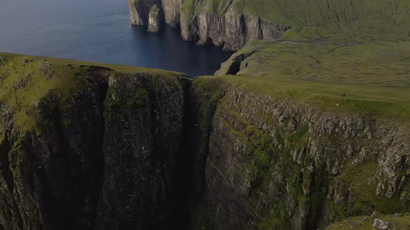 Drone Flight Descending Over Cliff Edges On Coastline