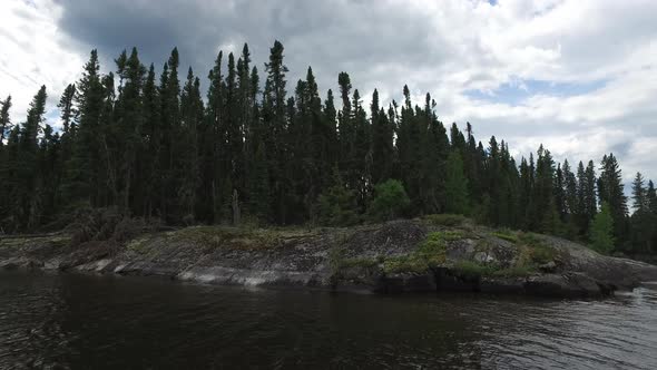 Rocks and forest on the lake shore