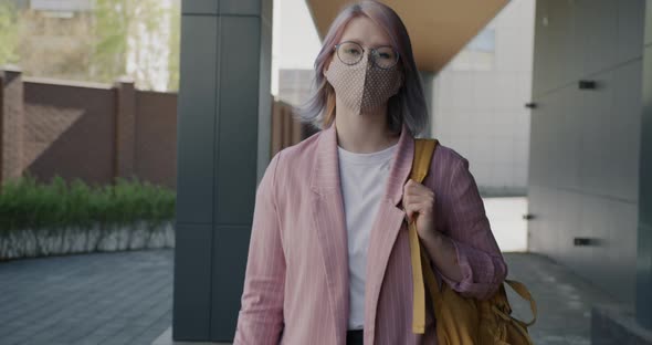 Dolly Shot of Attractive Young Lady Wearing Face Mask Walking Outdoors in Empty City Street