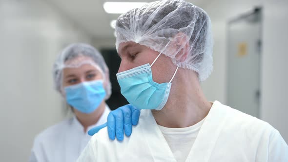 Closeup Portrait of Sad Overworking Doctor Touching Hand of Colleague Supporting Coworker