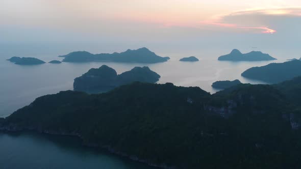 Aerial: flying over Cat Ba and Ha Long Bay rock pinnacles at sunset, tourism destination vietnam