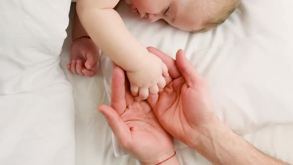 Little Baby Sleeping Father Gives By the Hand