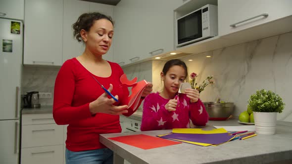 Loving Mother Spending Time with Daughter Making Applique at Home