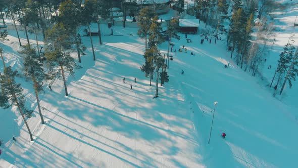 Skiers Go Down Hill Track at Popular Winter Resort Aerial