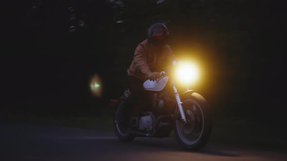 Motorcycle Riding on a Dark Road Wide Tracking Shot