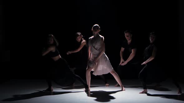 Start of Contemporary Dance Performance of Five Dancers on Black, Shadow