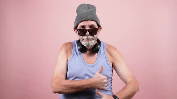 Cool mature man showing thumbs up gesture