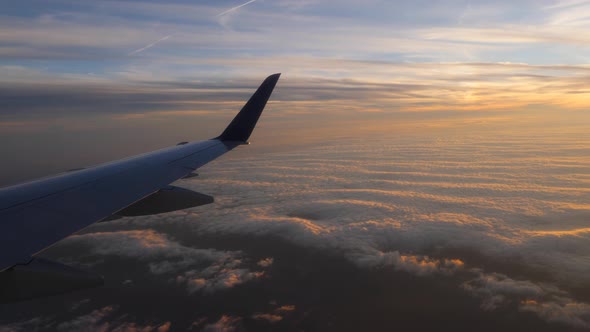 Aerial view of sunset through airplane window