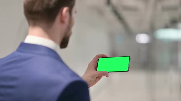 Businessman Watching Smartphone with Green Chroma Key Screen