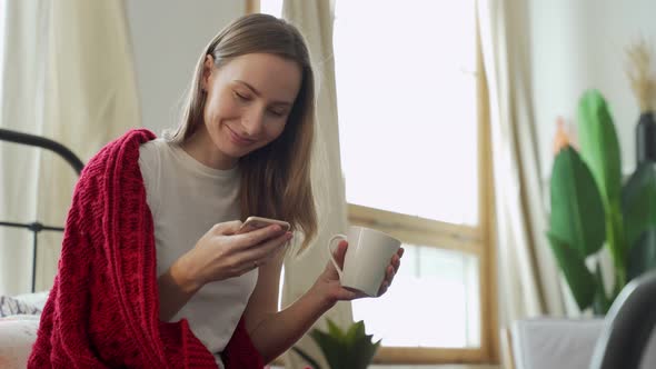 Woman Uses a Mobile Phone for Online Chat Online Communication Receives a Text Message Sits on the