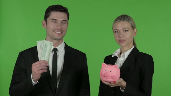 Engineers Posing with Piggy Bank and Dollars, Chroma Key