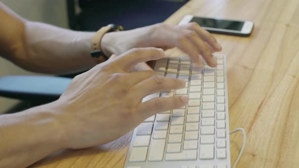 Man typing on keyboard