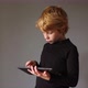 Portrait of young boy while surfing the internet on tablet - VideoHive Item for Sale