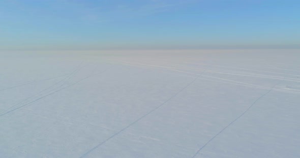 Aerial View of Cold Winter Landscape Arctic Field Trees Covered with Frost Snow Ice River and Sun