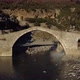 Aerial drone view of two fishermen below bridge - VideoHive Item for Sale
