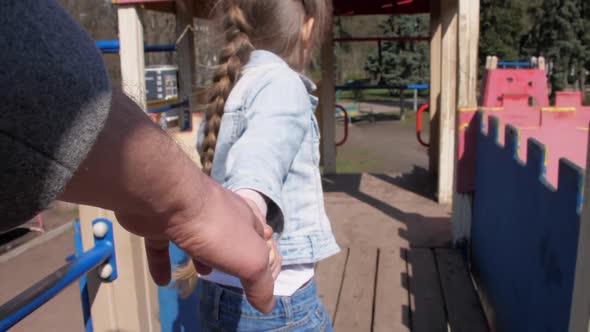 Young Schoolgirl Blonde Holds Stepfather Hand and Walks