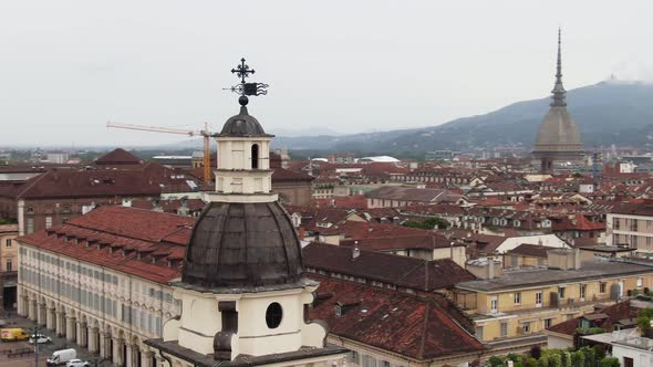 Church tower and city skyline of Turin, aerial drone orbit view