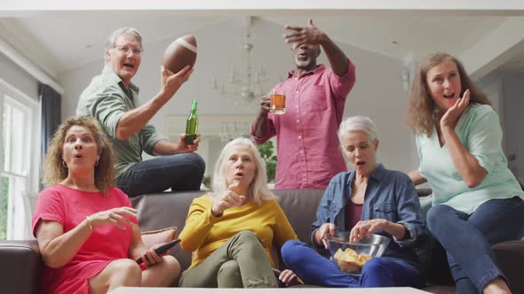 Animation of happy diverse senior friends cheering while watching american football match in tv