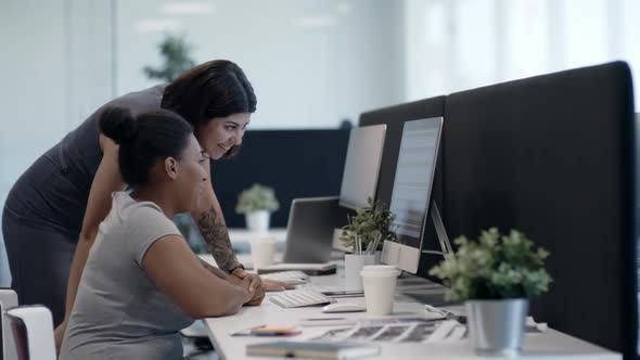 Joyous Female Colleagues Working on Computer Together