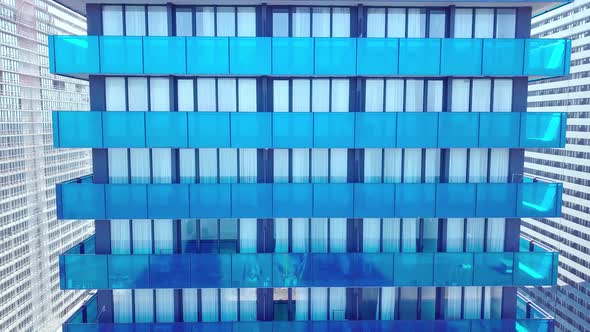 shot of reflections of sun, clouds and sky on glass windows of city skyscraper.