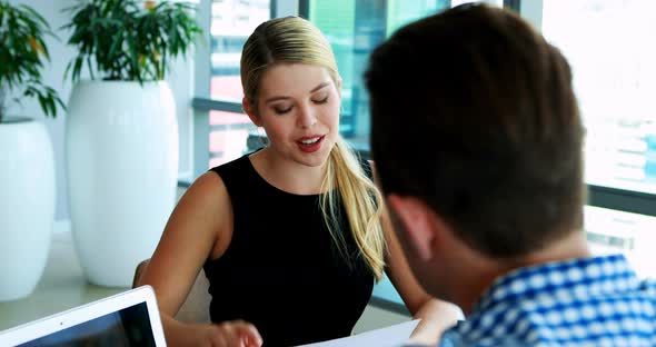 Executives interacting with each other at desk