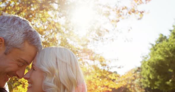 Man and woman touching noses outdoors