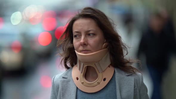 Portrait of an Adult Woman with a Medical Neck Brace To Treat a Neck Injury, Modern Lifestyle, She