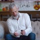 Bearded Mature Man with Grey Hair Playing on His Smartphone Exciting Mobile Application Racing Video - VideoHive Item for Sale