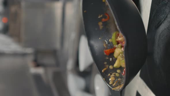 Chef Tossing Vegetables In Wok Pan