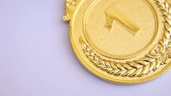 Top View of Winner or Champion Gold Trophy Medal Rotating on White Background
