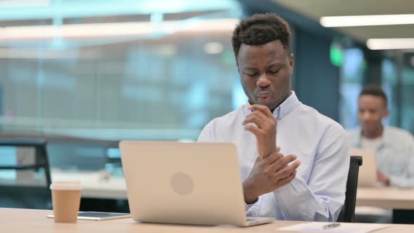 African Businessman with Laptop Having Wrist Pain