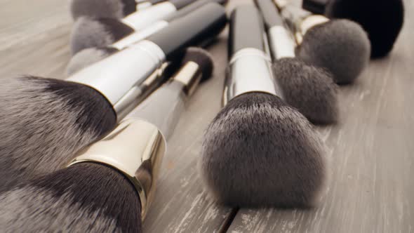 Cosmetics and Beauty Concept. Make-up Brushes on Wooden Table