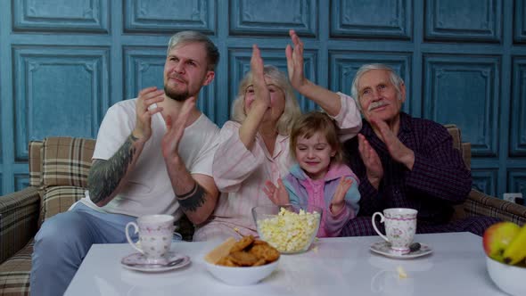 Multigenerational Happy Family Laughing Watching Comedy Cartoons Television Movies Eating Popcorn