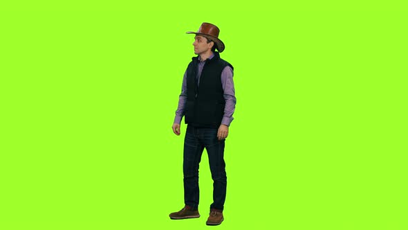 A Man in Cowboy Hat Walks and Meet Someone Against a Green Screen, Chroma Key