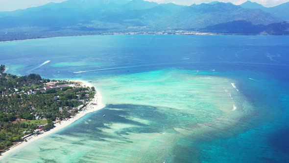 Luxury fly over travel shot of a sandy white paradise beach and blue ocean background in high resolu