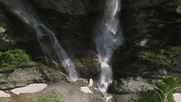 Aerial View of a Glacial Waterfall High in the Mountains on a Sunny Day