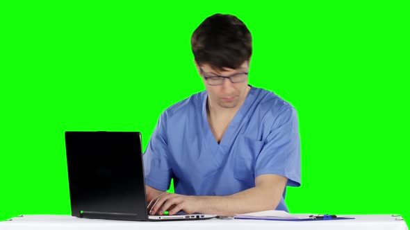 The Doctor Works at the Computer. Green Screen