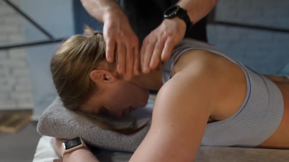 An Osteopath Does a Neck Massage to a Young Female Female Enjoy a Massage Neck and Spine Health