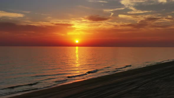 Beach and Calm Sea Surface During Sunset