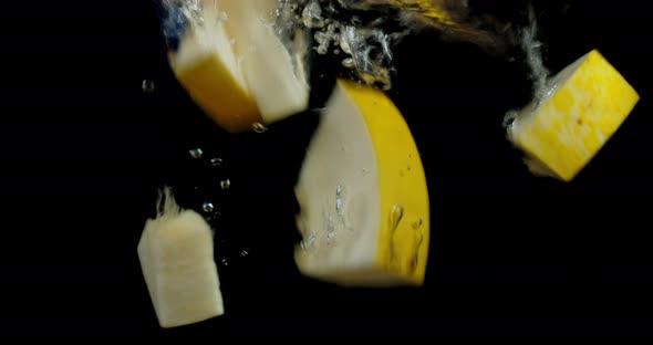 Slices of Melon Fall Into the Water with Air Bubbles. 