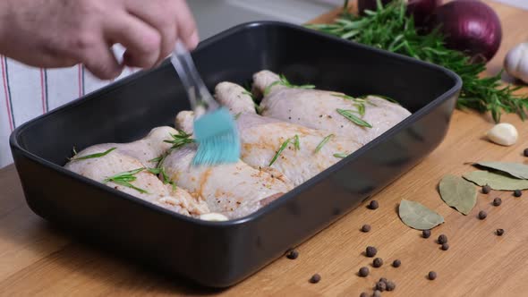 Cook greases the chicken with oil sauce with a silicone brush