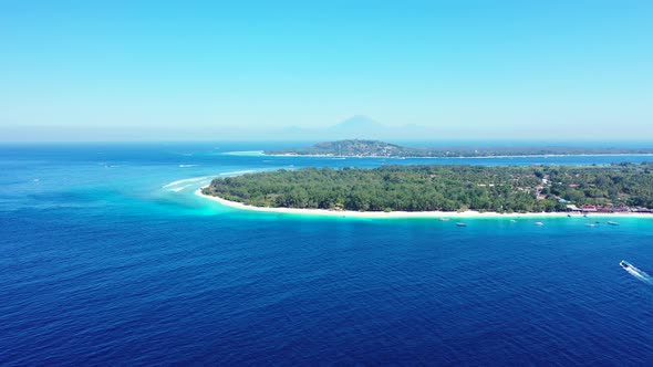 Wide angle flying clean view of a paradise sunny white sand beach and aqua blue ocean background in 