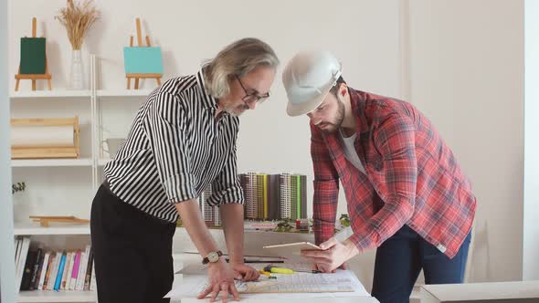 Young Engineer Man Mastering New Knowledge By Professional Architect