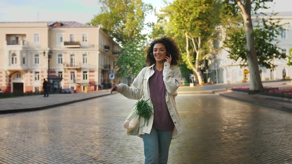 African American Woman in Headphones and Casual Clothes