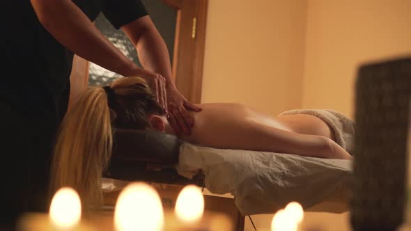 The Client Enjoys a Back Massage in the Massage Spa Salon Face Down