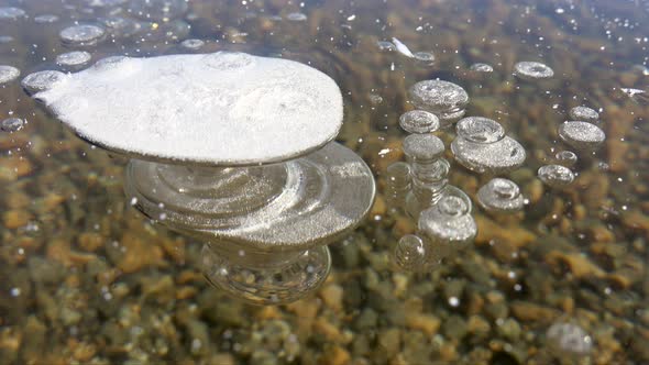 Frozen Methane Air Bubbles Trapped Under a Thick Floe Glassy Ice in Lake